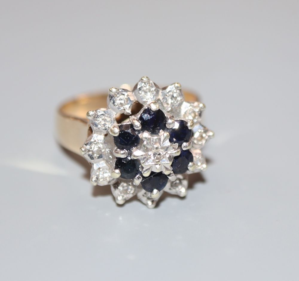 A modern 9ct gold, sapphire and diamond cluster ring, size M, gross 4.9 grams.